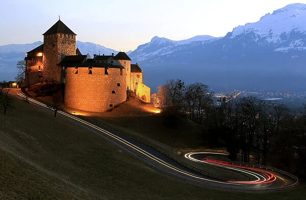 Cars drive past Vaduz Castle in Liechtensteins capital Vaduz