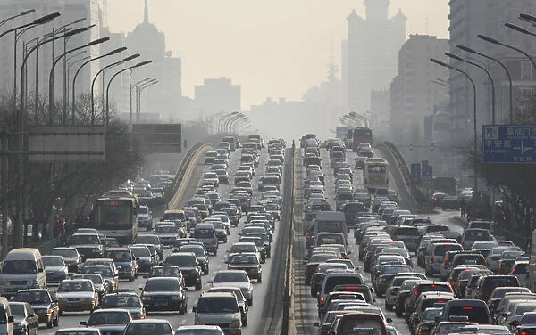 Cars are driven on one of the ring roads in Beijings city centre