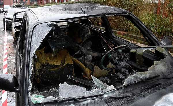 Several cars are seen, after they were torched in the early hours of the morning