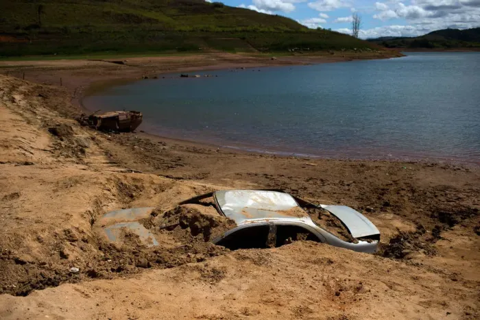 Framed Print : Cars suspected to be stolen and dumped in Jaguari lake appear on dry ground during a