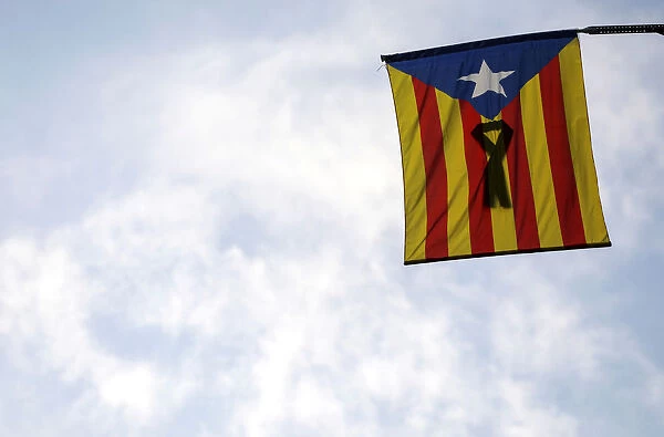 A Catalan separatist flag with a black ribbon hangs from a balcony in Barcelona