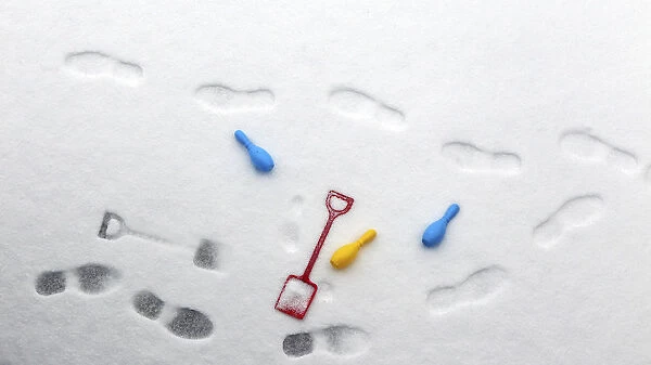 A childs spade and skittles rest in the snow in the seaside village of Ballycastle