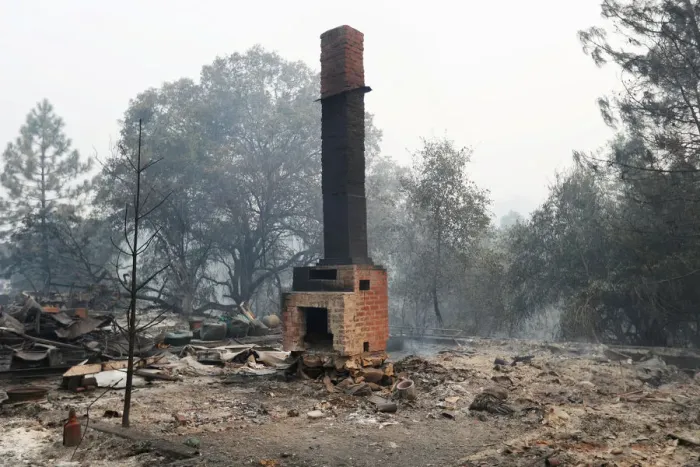Framed Print : A chimney stands amidst remains of a home destroyed by the Detwiler fire in Mariposa