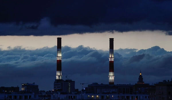 Chimneys of a heating power plant are pictured on a stormy evening in Moscow