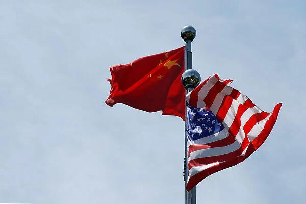 Chinese and U. S. flags flutter near The Bund in Shanghai