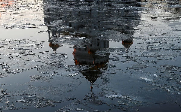The Christ the Saviour Cathedral is reflected on the icy Moskva river in Moscow