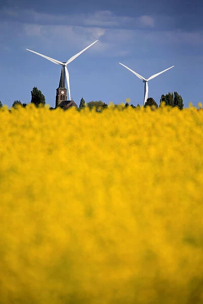 Church and windmills of the village of Saint-Hilaire-Lez-Cambrai are seen behind a