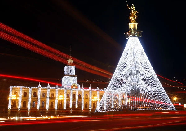 City Hall and the Freedom Monument are illuminated with Christmas decorations on the