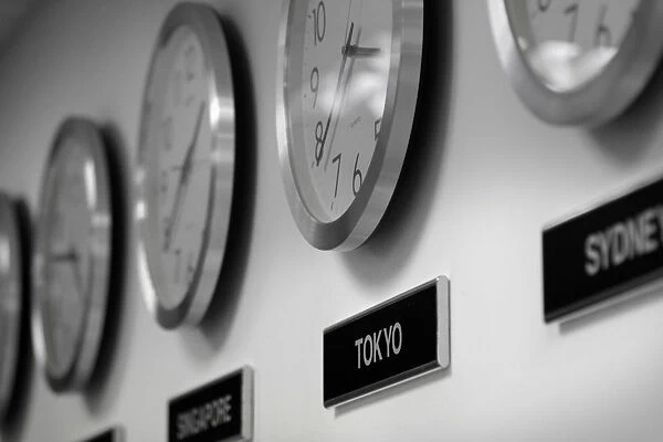 Clocks are seen on the wall of an office in Singapore