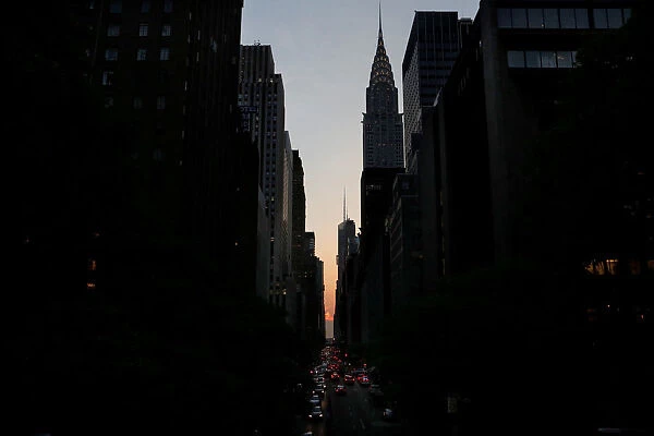 A cloud blocks the sunset on 42nd St in Manhattan during the phenomenon known as
