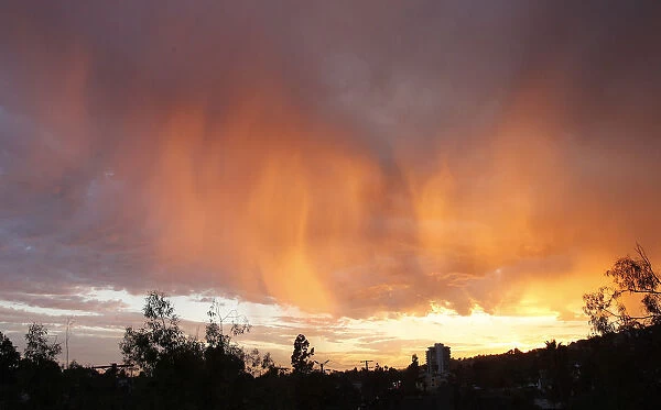 Cloud formations are illuminated by the sun as it sets in Los Angeles