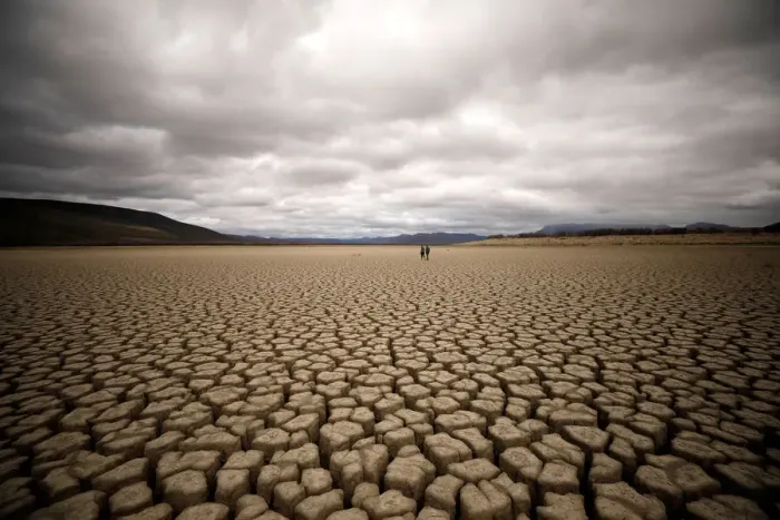 Framed Print : Clouds gather but produce no rain as cracks are seen in the dried up municipal dam in Framed Print : Clouds gather but produce no rain as cracks are seen in the dried up municipal dam in