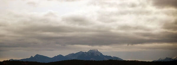 Clouds hang over the mountains on a rainy day near Holzkirchen