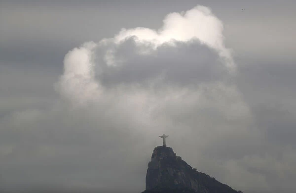 Clouds pass the Christ The Redeemer statue on Corcovado mountain, ahead of the Rio