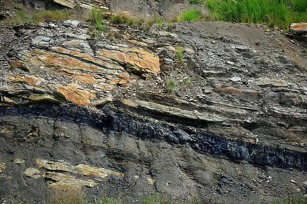 A coal seam can be seen in the rock along the highway in Partridge