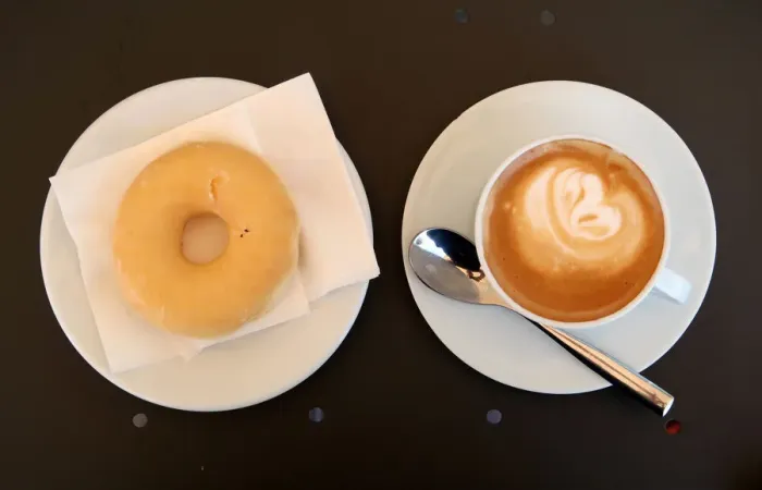Framed Print : A coffee with milk and a donut are served in bakery in Vilassar de Dalt town Framed Print : A coffee with milk and a donut are served in bakery in Vilassar de Dalt town