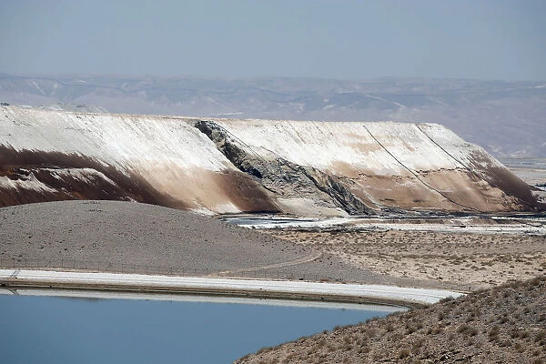 A collapsed wall of a reservoir holding a highly acidic wastewater is seen in Mishor