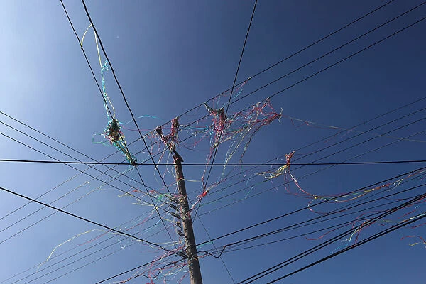 Color ribbon are seen on overhead power lines after firecrackers were set off during
