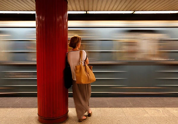 A commuter waits for a train at a subway station in Budapest