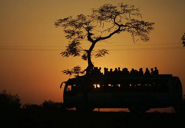 Commuters travel on a bus on a highway near Midnapore town