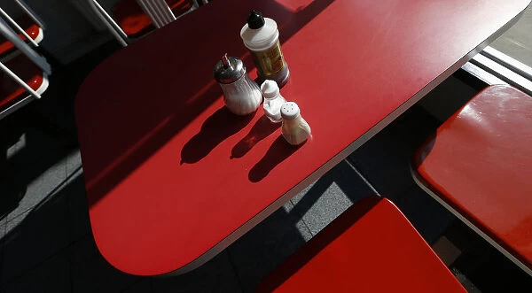 Condiments are seen on a table inside The Arsenal Fish Bar restaurant in north London