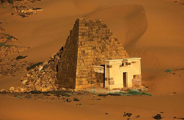 Creeping desert sands surround the Royal Cemeteries of Meroe Pyramids in Begrawiya at