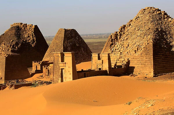 Creeping desert sands surround the Royal Cemeteries of Meroe Pyramids in Begrawiya at