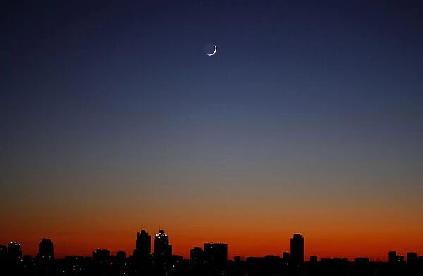 A crescent moon is seen over Buenos Aires at sunrise