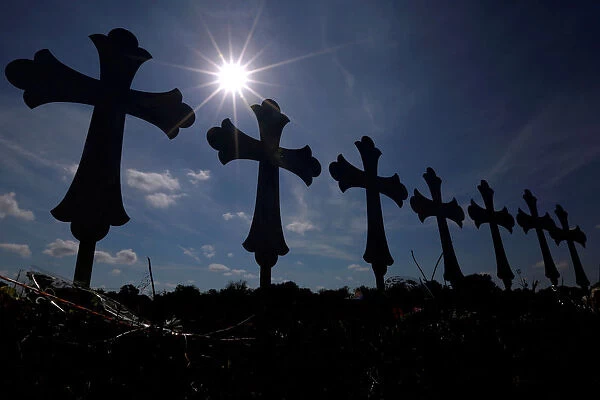 Crosses are seen placed at a memorial in memory of the victims killed in the shooting at