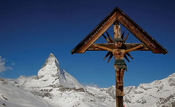 A crucifix is seen in front of mount Matterhorn near Zermatt