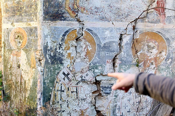 A damaged fresco is pictured in The Orthodox Church of Saint Athanasios in Muzina