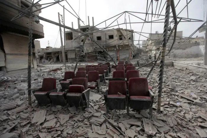 Framed Print : Damaged seats are pictured amidst rubble of buildings in the northern Syrian town of Framed Print : Damaged seats are pictured amidst rubble of buildings in the northern Syrian town of