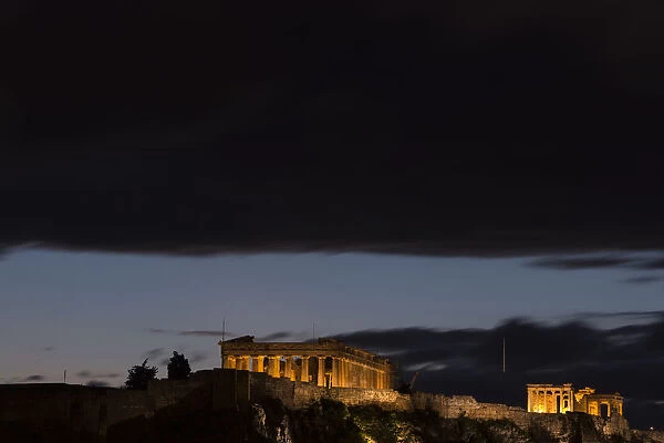 Dark clouds gather above the Parthenon Temple at the archaeological site of the Acropolis