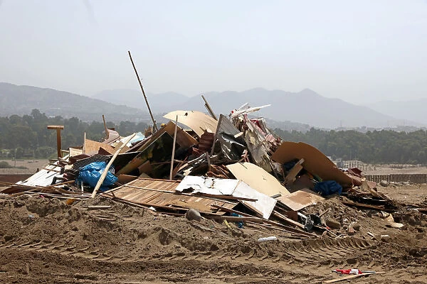 Debris of huts are seen after police evict squatters from a land in Villa El Salvador