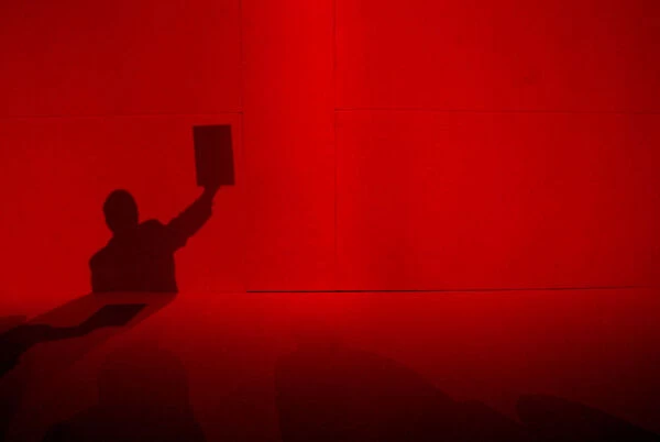 A delegates shadow is cast on the backdrop of the Labour party conference hall as