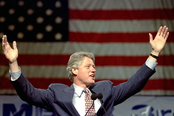 Democratic presidential candidate Bill Clinton raises his arms to supports during
