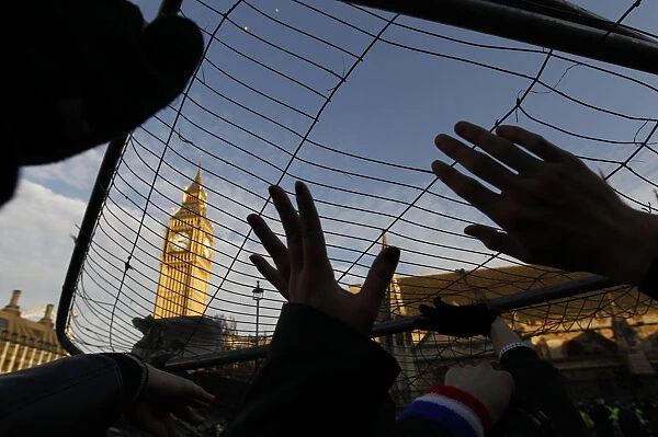 Demonstrators hold barriers above their heads in Parliament Square in central London
