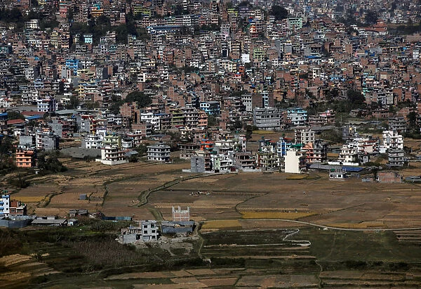 Densely built houses sift toward the farmlands due to the population growth in Kathmandu
