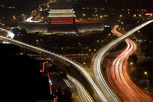 The Deshengmen Embrasure Watchtower is lit by coloured lights in Beijing