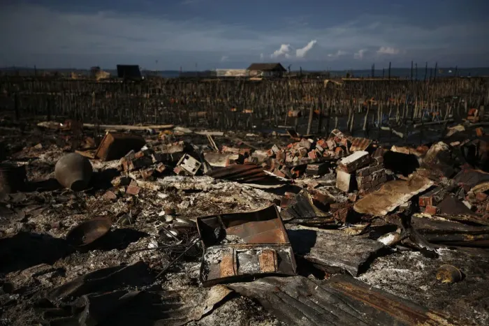Framed Print : Destroyed items are scattered in the ruins of a neighborhood burnt in violence Framed Print : Destroyed items are scattered in the ruins of a neighborhood burnt in violence