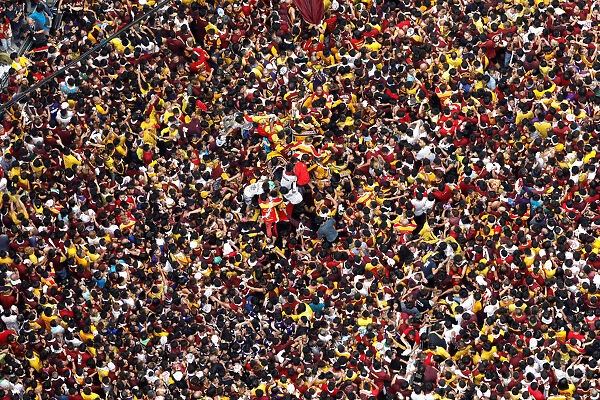 Devotees jostle as they try to reach an image of the Black Nazarene during the annual