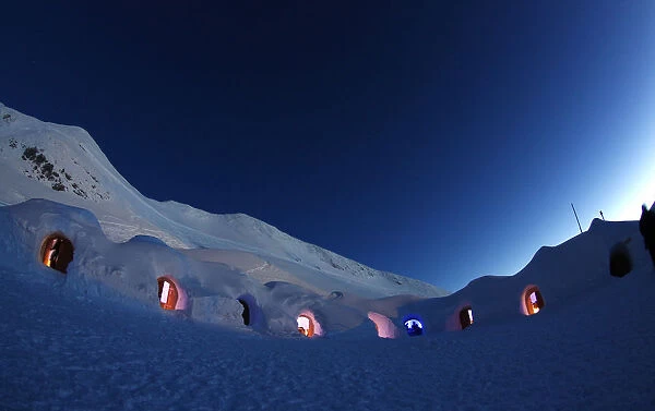 Dimmed lights are switched on in igloos on top of the mountain Nebelhorn near Oberstdorf