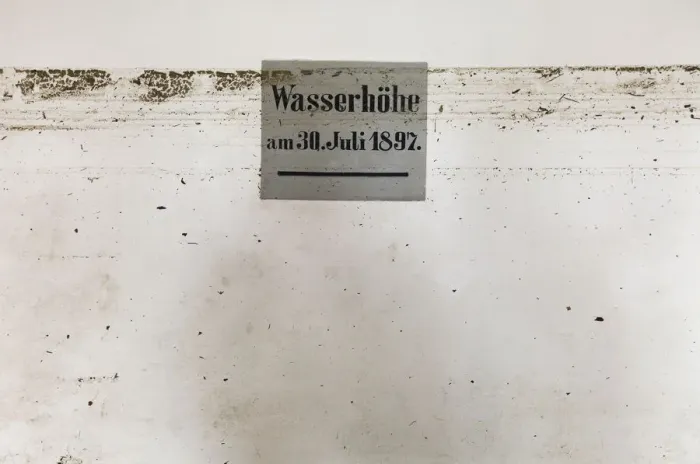 Framed Print : Dirt marks from recent flood run across sign showing height of 1897 flood in Framed Print : Dirt marks from recent flood run across sign showing height of 1897 flood in