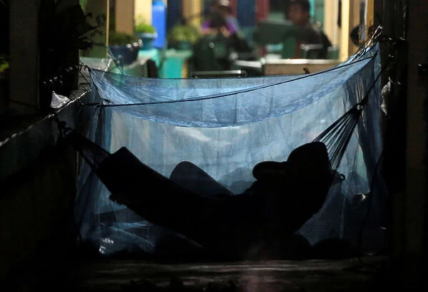 Displaced Filipinos sleep at the hallway of the evacuation center after Mount Mayon