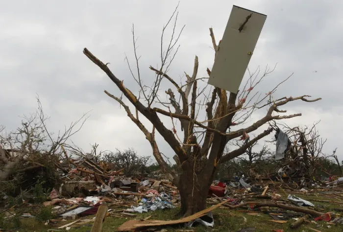 Framed Print : The door of a house is impaled on a tree after tornados swept through the town of