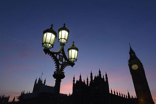 Dusk falls behind the Houses of Parliament on a clear evening in Westminster