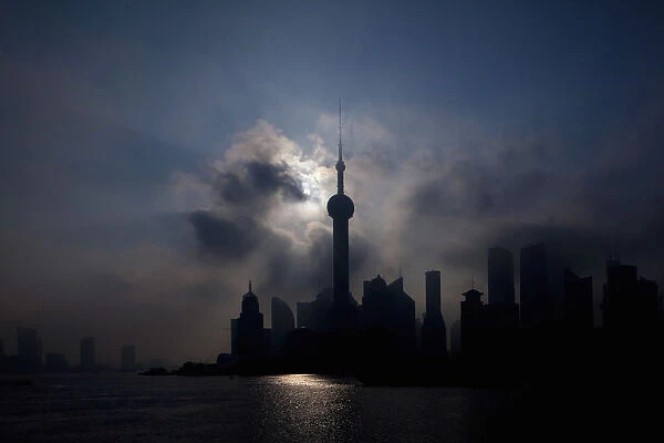 An eclipse is seen in at the Bund along the Huangpu River in Shanghai