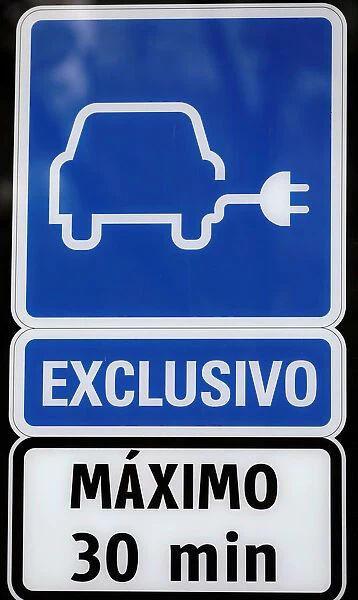 Electric car charging sign is pictured at a charging point for electric vehicles in