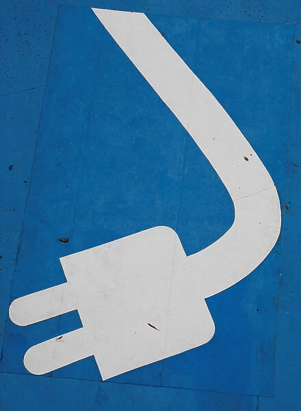 Electric car charging sign is seen in a car park at a petrol station in Sao Paulo