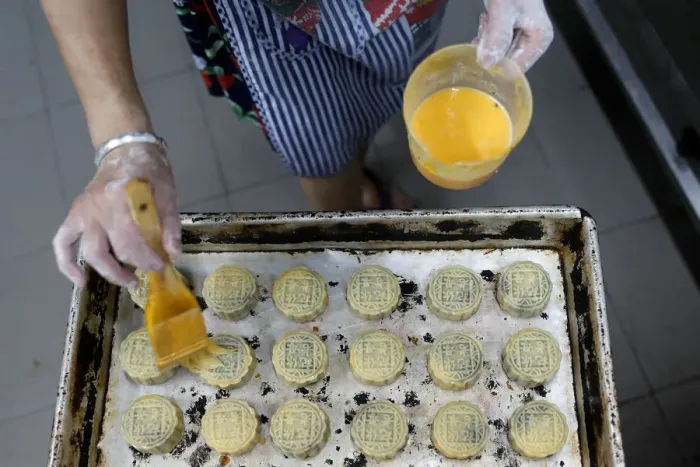 Framed Print : An employee makes mooncakes with anti-extradition bill slogans at Wah Yee Tang Bakery in Framed Print : An employee makes mooncakes with anti-extradition bill slogans at Wah Yee Tang Bakery in